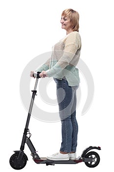 in full growth. attractive casual woman with electric scooter.