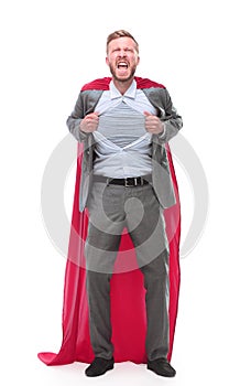 In full growth. businessman in superhero Cape rips his shirt.