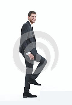 Full growth.businessman taking a step forward.isolated on white.
