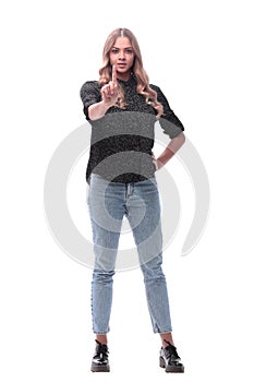 In full growth. confident young woman showing a gesture of attention