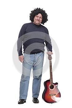 in full growth. curly-haired mature man with a guitar.