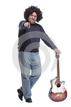 in full growth. curly-haired mature man with a guitar.