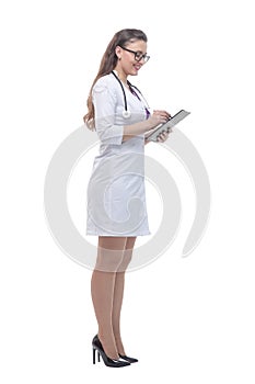 In full growth. female doctor reading notes in her tablet