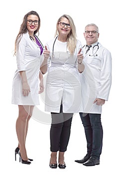 In full growth. a friendly female doctor standing in front of her colleagues.