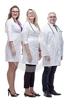 In full growth. a friendly female doctor standing in front of her colleagues.