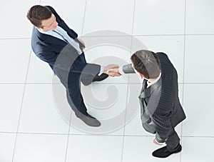 In full growth.handshake, business partners ,isolated on white background.