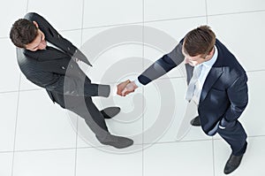 In full growth.handshake, business partners ,isolated on white background.