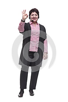 In full growth. Mature woman in headset showing thumbs up