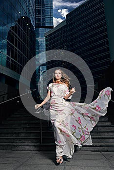 Full growth portrait of fashionable woman on urban background