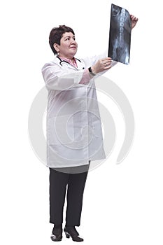 in full growth. a smiling female doctor examining an x -ray of a patient