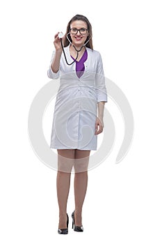 In full growth. smiling female doctor showing her stethoscope.