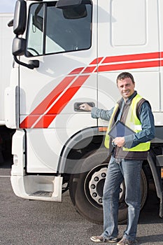 a full handsome truck driver worker in front vehicule