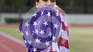 Full of happiness athlete woman holding flag of USA and enjoying victory slow-mo