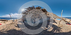 Full hdri seamless spherical 360 panorama near thatched hut with daybeds and cushions for relaxing or palm tree hut on Red Sea