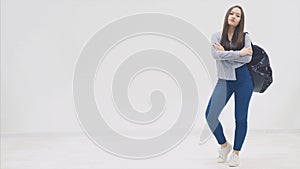 Full height asian, girl with long hair appearing on a white background with backpack slung over her shoulder, and hands