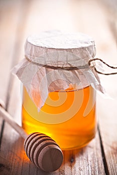 Full honey pot and honey stick