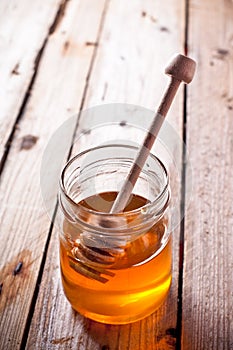 Full honey pot and honey stick