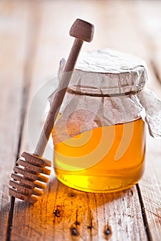 Full honey pot and honey stick