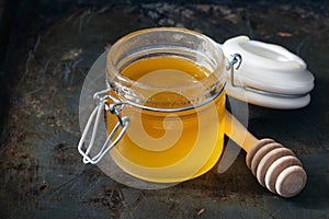 Full honey pot and honey stick