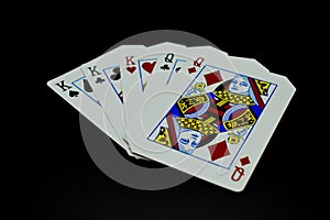 Full house kings over queens cards in poker game against black background