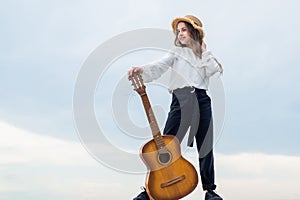 full of inspiration. freedom and success. singer. happy teen girl playing guitar outdoor.