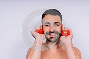 Full isolated studio picture from a young naked man with underwear and tomato