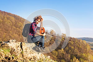 full of joyful feeling satisfaction for beautiful blonde young woman playing alone the acoustic guitar ukulele with the