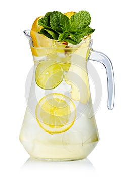 Full jug of fresh birch juice with lemon, ginger and mint leaves