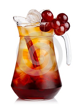 Full jug of fresh nonalcoholic cocktail with grapes and cinnamon photo