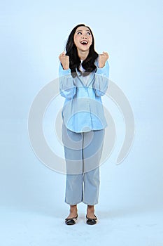 full leght shoot of happy asian Indonesian woman wearing casual attire on isolated background photo