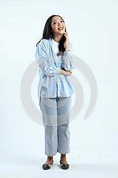 full leght shoot of happy asian Indonesian woman wearing casual attire on isolated background photo