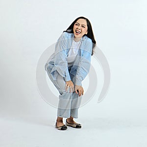 full leght shoot of happy asian Indonesian woman wearing casual attire, laugh out loud on isolated background