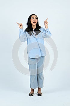 full leght shoot of happy asian Indonesian woman wearing casual attire, pointing finger on isolated background