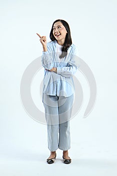 full leght shoot of happy asian Indonesian woman wearing casual attire, pointing finger on isolated background