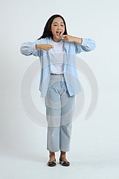 full leght shoot of happy asian Indonesian woman wearing casual attire showing eating gesture on isolated background