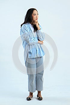 full leght shoot of pensive asian indonesian woman on isolated background