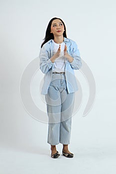 full leght shoot of pensive asian indonesian woman on isolated background