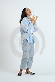 full leght shoot of stressful asian indonesian woman on isolated background photo