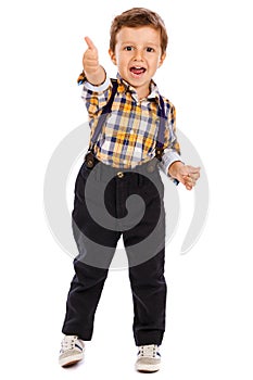 Full lenght portrait of an adorable little boy showing thumbs up
