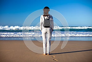 Full lenght portrait of young woman enjoy ocean on beach