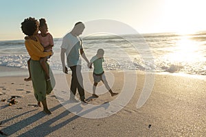 Full length of african american enjoying summer sunset at beach