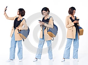 Full length of Asian Indian 20s working woman with curl hair hold cell smart phone backpack blazzer