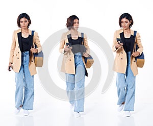 Full length of Asian Indian 20s working woman with curl hair hold cell smart phone backpack blazzer