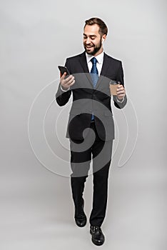 Full length of an attractive smiling young businessman