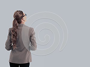 Full-length back side of businesswoman, isolated on white.