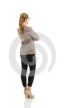 Full-length back side of businesswoman, isolated on white.