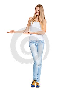 Full length of beautiful blond woman pointing at copy space isolated
