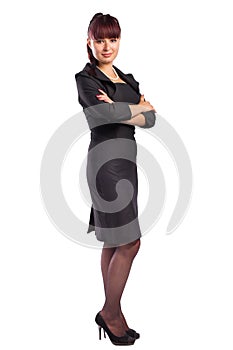 Full length of beautiful business woman standing with arms folde