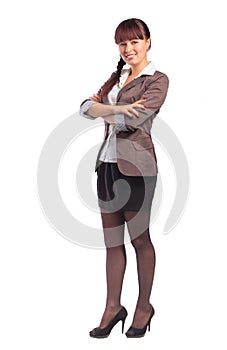 Full length of beautiful business woman standing with arms folded