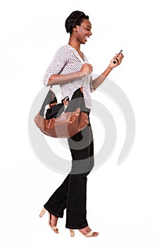 Full length beautiful tall african american woman with purse and smart phone